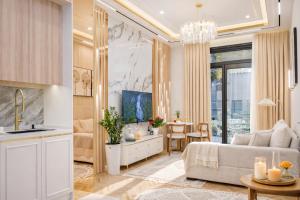 a living room with a couch and a table at NOVA HOME Apartments - NEST ONE, Panoramic Views, Tashkent City in Tashkent