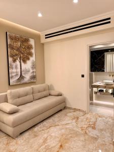 a living room with a couch and a tree on the wall at The Residence Myrina in Myrina