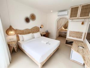 a bedroom with a bed and a room with a table at Khaiyyara Jimbaran Bali in Uluwatu +56 photos