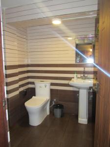 a bathroom with a toilet and a sink at HOTEL LAYAKU DURBAR in Bhaktapur +78 photos