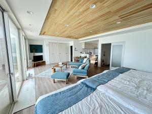 a bedroom with a large bed and a living room at Lapita Resort in Sakai +29 photos