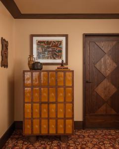 a chest of drawers in a room with a door at Hotel Saint Roch in Courchevel