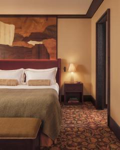 a hotel room with a bed and a painting on the wall at Hotel Saint Roch in Courchevel +11 photos