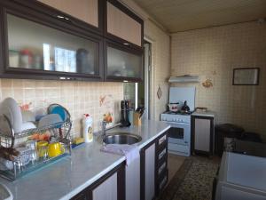 a kitchen with a sink and a counter top at Samia House Room on Furqat 8 in Tashkent