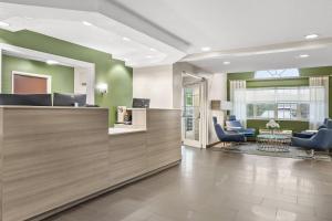 an office lobby with a reception desk and chairs at Quality Inn & Suites Nashville - Bellevue in Nashville +37 photos