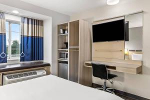 a hotel room with a bed and a desk and a tv at Quality Inn & Suites Nashville - Bellevue in Nashville