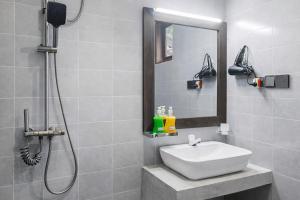 a bathroom with a sink and a shower with a mirror at Jackhill Hiriketiya in Dickwella +24 photos