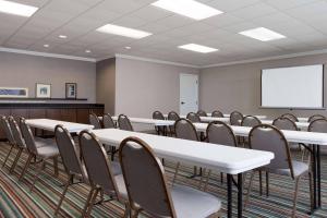a conference room with tables and chairs and a whiteboard at Country Inn & Suites by Radisson, Jackson, TN in Jackson