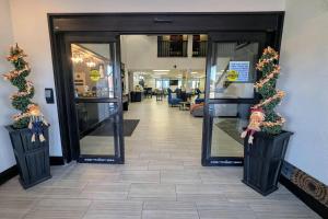 an entrance to a lobby with christmas wreaths at Quality Inn Warrensburg in Warrensburg +26 photos