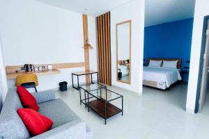 a living room with a couch and a bed and a mirror at Alfa Jivana Resort in Sampal 2 +47 photos