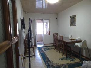 a dining room with a table and a table and chairs at Samia House Room on Furkat 8 in Tashkent