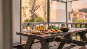 a wooden table with food on it on a balcony at Daebudo Sketch Pension in Ansan