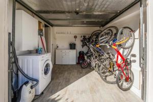 a garage with two bikes hanging on the wall at La douce echappée in Trèbes