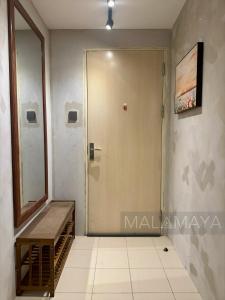 a door in a room with a mirror and a staircase at Malamaya Staycation in Manila +12 photos