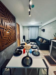 a table in a living room with plates on it at Malamaya Staycation in Manila
