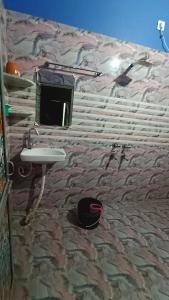 a bathroom with a stone wall with a sink at Hotel DEEPAK PALACE in Gaya +16 photos