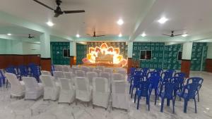 a room with rows of chairs and a fireplace at Hotel DEEPAK PALACE in Gaya