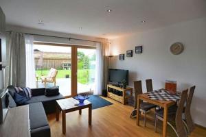 a living room with a couch and a table at Ferienwohnung "Ausblick" in Rötz