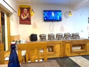 a kitchen with a stove and a tv on the wall at The Snowpeak Hunder in Hundar +15 photos