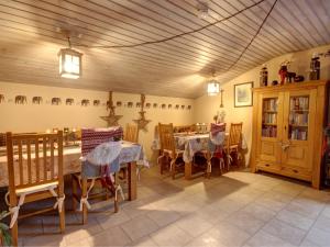 a dining room with tables and chairs and a room with animals on the wall at Gästehaus Barbara Schwaiger - Chiemgau Karte in Inzell