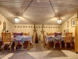 a dining room with tables and chairs and lights at Gästehaus Barbara Schwaiger - Chiemgau Karte in Inzell