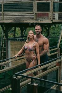 a man and woman in bathing suits standing on a bridge at Nirata Treehouse in Kintamani +38 photos