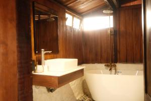 a bathroom with a sink and a bath tub at SIA Home - Dalat Haus in Ấp Ða Lợi