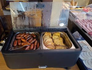 a tray of different types of pastries and other foods at HOTEL Tyrapol - izby in Oravská Lesná