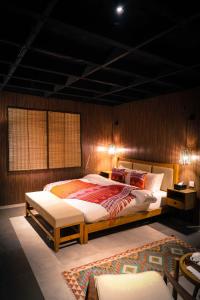 a bedroom with a large bed with lights on it at Semari Resort in Muzaffarabad