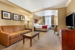 a hotel room with a couch and a bed at Comfort Inn Arcata in Arcata