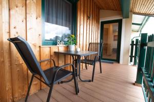 a table and two chairs on a porch at Rebenhof Schwalm in Herrnbaumgarten