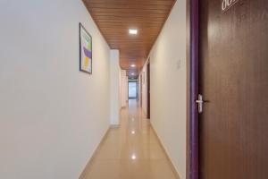 a hallway in a building with a wooden ceiling at Treebo Pratham Inn Water Park Resort With Swimming Pool in Kundapur