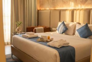 a hotel room with a bed with towels on it at Clarion Hotel Hyderabad in Hyderabad +122 photos