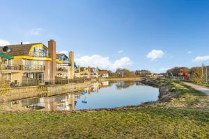 a river with houses on the side of it at Villa Beach & Spa in Julianadorp