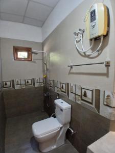 a bathroom with a white toilet and a shower at Noel Villa in Galle