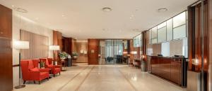 a lobby with red chairs and a waiting room at Crown Park Hotel Seoul Myeongdong in Seoul