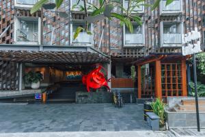 a statue of a person in front of a building at ARTOTEL Sanur Bali in Sanur