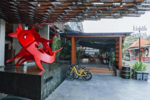 a red dragon statue on the side of a building at ARTOTEL Sanur Bali in Sanur