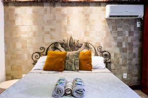 a bed with two pairs of slippers on it at Suites Belos Ares in Búzios