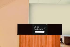 a black sign on top of a wooden partition at Super Collection O Madhapur in Hyderabad