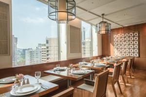 a restaurant with wooden tables and chairs and large windows at Crown Park Hotel Seoul Myeongdong in Seoul +46 photos