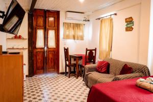 a living room with a couch and a table at Suites Belos Ares in Búzios