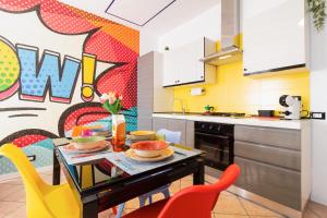 a kitchen with a table with bowls of food on it at Black & White or Pop Art - Design Apartments with Parking & WiFi in Saronno +33 photos
