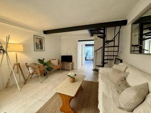 a living room with a white couch and a loft at Casa Borguny - House in the centre of Palma in Palma de Mallorca