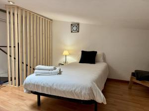 a bedroom with a bed with towels on it at Casa Borguny - House in the centre of Palma in Palma de Mallorca