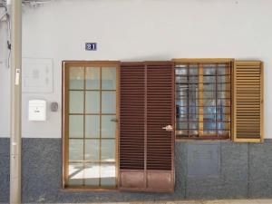 a wooden door and window on a building at Casa Borguny - House in the centre of Palma in Palma de Mallorca +25 photos