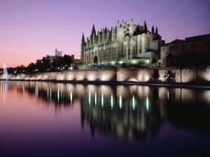 a large building next to a body of water at Casa Borguny - House in the centre of Palma in Palma de Mallorca