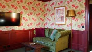 a living room with a couch and a tv at Lejondals Slott in Bro