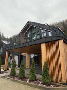 a house with a balcony on top of it at Goldhill villa in Yaremche