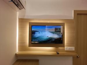 a flat screen tv on a wall in a room at Hotel Niko International in Bodh Gaya